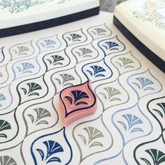 a small pink object sitting on top of a patterned floor