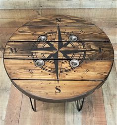 a wooden table that has a compass on it