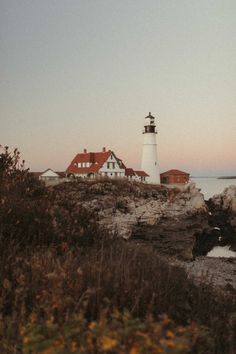 a light house sitting on top of a cliff next to the ocean