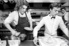 two men are in the kitchen preparing food