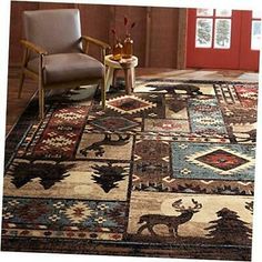 a living room with a chair and rugs on the floor in front of a red door