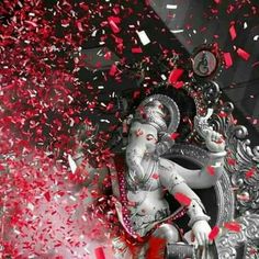 the statue is surrounded by red confetti