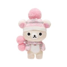 a small stuffed bear wearing a pink hat and scarf with pom - poms