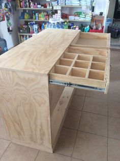 a wooden table with drawers on it in a store