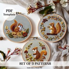 three embroidery kits with squirrels and leaves on them, one is in the hoop