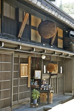 an outside view of a building with some items hanging from the roof and on the wall