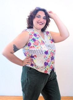 This is a very cute 90s boho floral vest by Passports of Pier 1 Imports! It's a lightweight, breezy gauze rayon vest that could also be worn as a sleeveless top. It has a painterly flower print in purple, dusty rose pink, yellow and green, with a blue windowpane design on a beige background. It has a lapped V neck, generously cut arm holes, a hem that comes to two points in the front, and it closes with five marbled tan front buttons.The vest is in good clean condition, no flaws noted. The label 90s Boho, Floral Vest, Floral Vests, 90s Floral, Pier 1 Imports, Beige Background, Pier 1, Boho Floral, Womens Vest