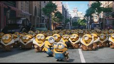 a group of minions from despicable me standing in the middle of a street