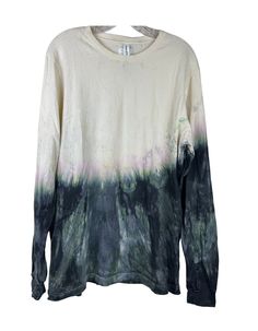 a white shirt with black and green dye on it