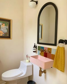 a bathroom with a sink, mirror and toilet