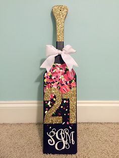 a wine bottle with a pink and gold number on it