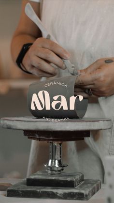 a close up of a person cutting something on top of a plate with the word mar written on it