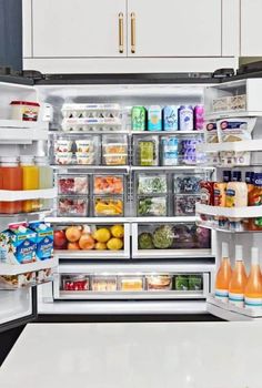 an open refrigerator filled with lots of different types of drinks and food in it's doors