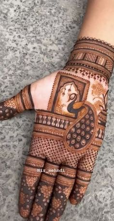 the hand is decorated with henna designs