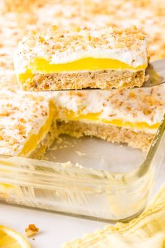 a close up of a cake in a pan with a fork and lemons on the side