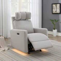 a white recliner chair sitting on top of a rug