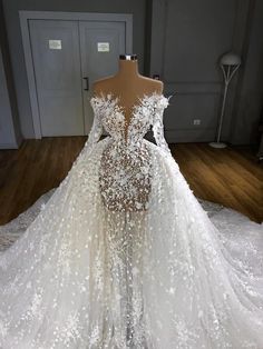 a white wedding dress with flowers on it