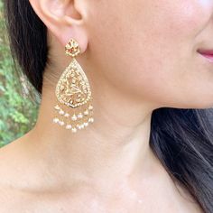 Featuring a pair of pearl earrings in gold plated silver. It has been embellished with precious freshwater pearls. The earrings have a bombay screw. Festival Pearl Jhumkas With Pearl Drop, Pearl Drop Jhumkas For Festivals, Elegant Pearl Earrings With Intricate Design For Diwali, Festive Pearl Jhumkas With Pearl Drop, Elegant Kundan Pearl Earrings For Celebration, Elegant Chandbali Earrings With Pearl Chain, Elegant Pearl Earrings With Latkans For Party, Elegant Pearl Earrings For Festivals, Elegant Chandbali Pearl Earrings With Latkans