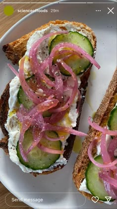 an open face sandwich with cucumbers and onions on it sitting on a white plate