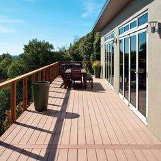 a wooden deck with table and chairs on it