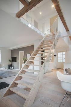 a living room filled with furniture and a stair case