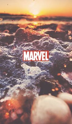 an image of the word marvel in front of some rocks and water at sunset or sunrise