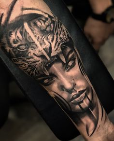 a man's arm with a tiger and woman tattoo on the left side of his arm