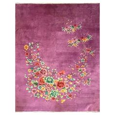 a purple rug with flowers on it and a crescent shaped object in the middle,