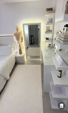 a bedroom with a bed, mirror and shelves on the wall next to each other