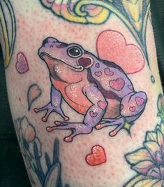 a frog with hearts and flowers on it's leg