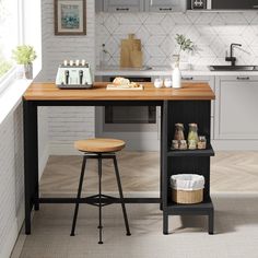 a kitchen with a table and stools in it