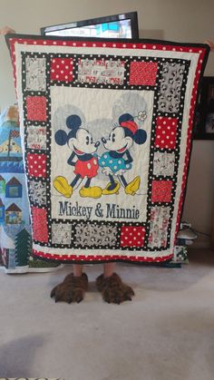 mickey and minnie quilt on the floor with slippers in front of it that says mickey & minnie