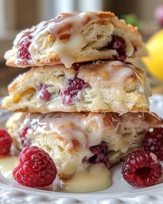 three raspberry filled pastries stacked on top of each other