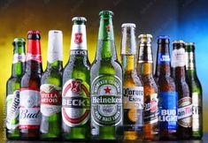 a group of beer bottles sitting on top of a wooden table next to each other