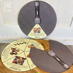 two circular discs with pictures on them sitting next to each other in front of a door