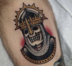 a skull with a crown on it's head is shown in this tattoo design