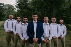 a group of men standing next to each other wearing ties and bow ties on their shirts