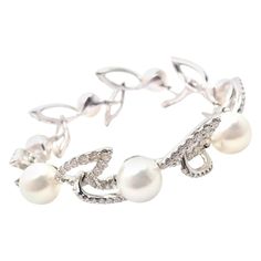 18k White Gold Diamond Cultured Pearl Link Bracelet by Mikimoto. With 213 round brilliant cut diamonds VS1 clarity, G color total weight approximately 7ct 7 cultured pearls 12mm each Details: Length: 7" Width: 19mm Weight: 9.4 grams Stamped Hallmarks: Mikimoto Logo 750 *Free Shipping within the United States* YOUR PRICE: $22,000 T2876mhtdd Mikimoto Pearls, Gold Link Bracelet, Round Brilliant Cut Diamond, Cultured Pearls, Brilliant Cut Diamond, Round Brilliant Cut, White Gold Diamonds, Pearl White, Round Brilliant