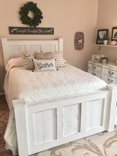 a white bed sitting in a bedroom on top of a carpeted floor next to a dresser