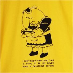 a yellow t - shirt with an image of a cartoon character holding a cell phone