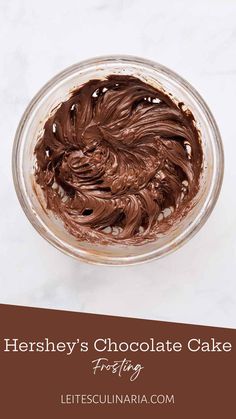 a chocolate cake in a glass bowl with the words hershey's chocolate cake frosting