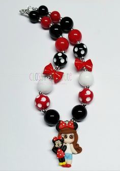 This listing is for one Minnie and Me Necklace.  Necklace is available in 16 or 18 inches in length.   Lobster clasp closure with a 2 inch extender chain.   20mm acrylic bubblegum beads in red, black, polka dot red and white, and polka dot black and white beads.   24mm red acrylic bow beads.  Pendant is made of polymer clay material.  6mm silver spacer beads.  Matching beaded bracelets available for additional charge upon requests. Just contact me.  Thank you for looking. 😊 Product color may di Cute Red Necklace For Parties, Plastic Bead Jewelry For Birthday, Plastic Round Beads Jewelry For Birthday, Playful Personalized Red Jewelry, Plastic Round Beads Necklace For Gift, Black Plastic Jewelry Gift, Fun Red Resin Jewelry, Cute Black Resin Jewelry, Fun Black Jewelry For Birthday