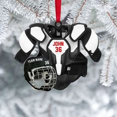 an ornament with a hockey goalie's gear hanging from a christmas tree