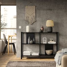 a living room filled with furniture next to a window and a rug on the floor