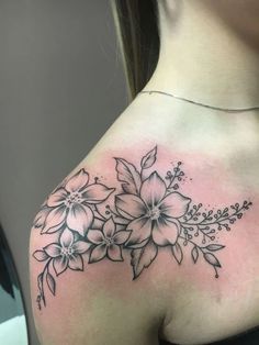 a woman's shoulder with flowers on it