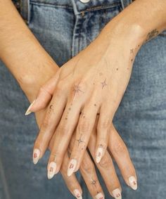 a woman's hands with tattoos on them