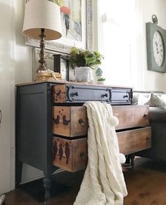 a living room with a couch, table and clock