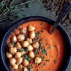 a bowl filled with soup and garnished with herbs