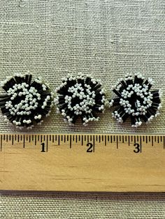 These fabulous antique glass hand-beaded embellishments date from the 1920/30's and are sewn from black glass bugle and pearly seed beads on a black cloth foundation. Embellishments are a wonderful addition to flowers, trims and other millinery creations. Each hand beaded piece measures 1 & 1/4th inches in diameter and is 3/8th of an inch in thickness. Excellent unused condition. Price d each piece. Black Round Beads With Bead Caps, Fake Roses, Beaded Embellishments, Beaded Leaf, Vintage Ribbon, Ribbon Trim, Antique Glass, Pretty Colours, Hand Beading