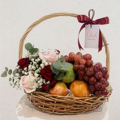 a basket filled with lots of fruit and flowers